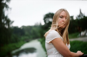 A woman in white in a windy day in summer