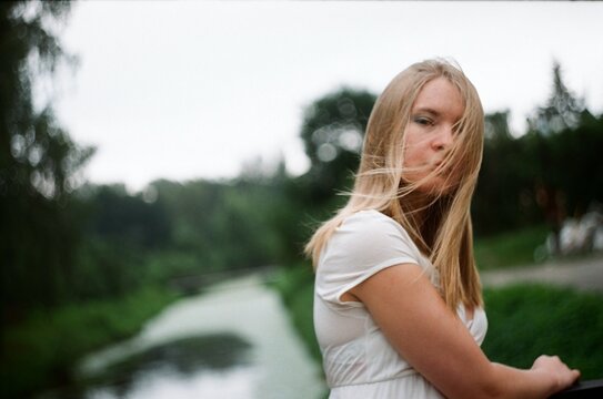 A woman in white in a windy day in summer