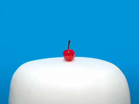 Simple white cake with a cherry on top