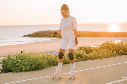 Female roller skating by the sea