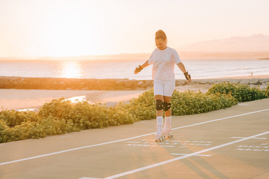 Woman roller skating by the sea