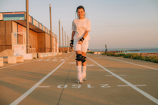 Female roller skater practicing in the seaside