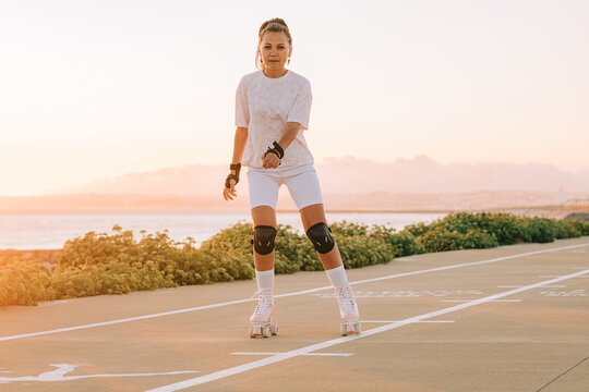 Woman roller skating by the sea