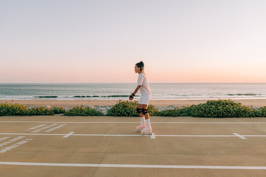 Woman roller skating by the sea