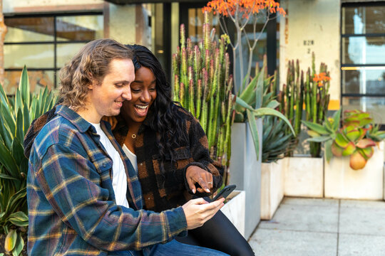 Couple Looks at Phone Outside in the Afternoon