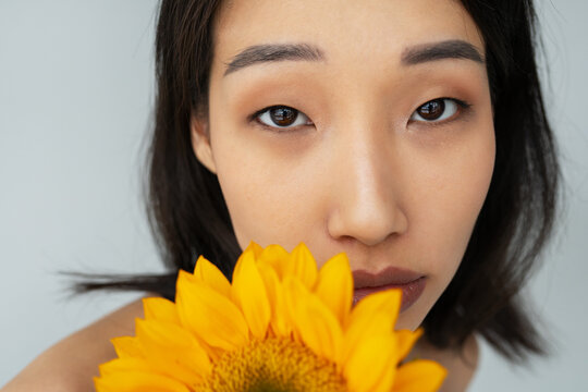 Closeup Portrait of Young Asian woman with flower