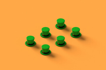 Collection of green st.Patrick hats on orange background