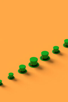 a row of green st.Patrick hats on orange background