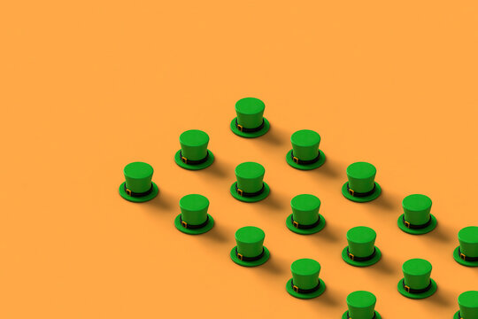 rows of green st.Patrick hats on orange background