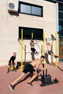 Sportspeople training on sports ground in summer