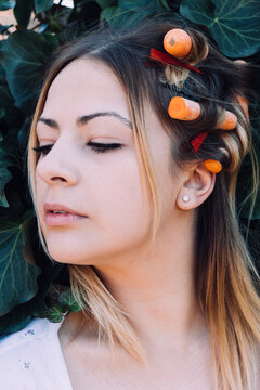young woman with carrots in her hair
