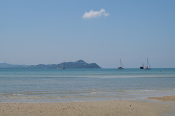 Fototapeta na wymiar Natural beautiful beach at Phang-nga island, Thailand. White beach, blue sky. Far mountains. 