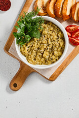 Eastern appetizer - babaganoush from eggplant with crispy bread. Eggplant dip on ceramic bowl in concrete background. Aesthetic composition with hummus. Arabic food. Oriental menu in minimal style.