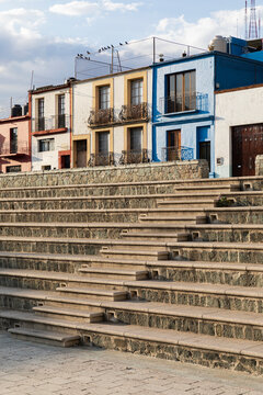 Stone staircase with a colored house and a sky in the background