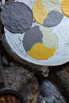 tortillas made with blue, white and yellow corn on a comal