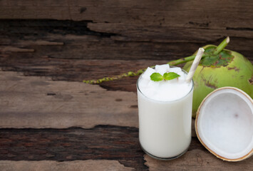 Coconut smoothie drink white fresh cocktail shake milkshake vanilla juice fruit beverage food healthy the taste yummy In glass on wooden background.