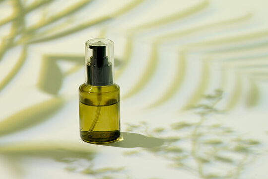 Blank green glass essential oil bottle with spray on green