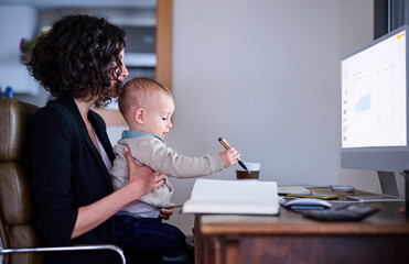 Mother with baby working at home