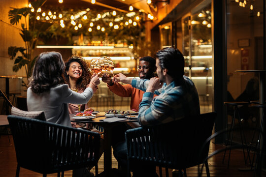 Top view of group of diverse friends clinking glasses
