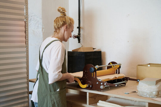 A pottery master uses a clay spreader