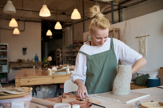 Master potter sculpts a vase with a terrazzo effect
