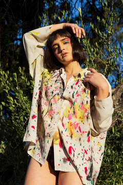 Cute young woman in painted shirt in summer