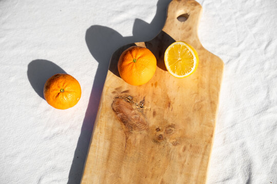 Handmade wooden cutting board with oranges