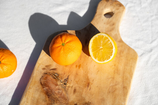 Handmade wooden cutting board with oranges