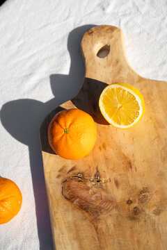 Handmade wooden cutting board with oranges