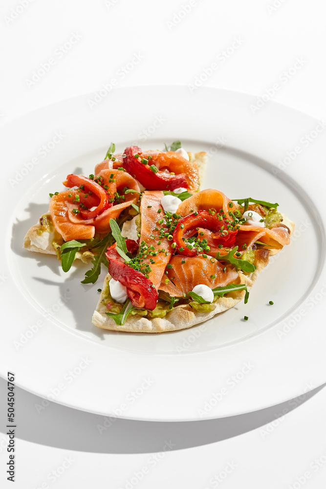 Canvas Prints bruschetta with salmon, avocado and paprika on white plate. salmon bruschetta on crispy focaccia. ap