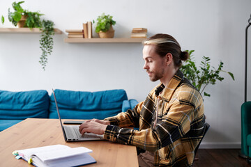 Young man working on his desk at the office