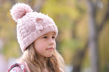 Portrait of cute little child girl in pink hat