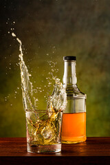 Whiskey splashing out of glass
