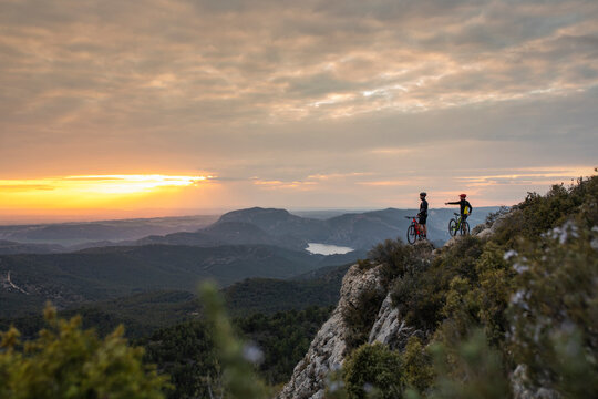 Two mountain bikers at sunset