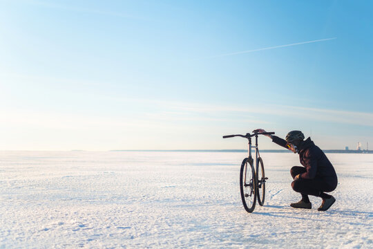 The rider on a bicycle rides on ice