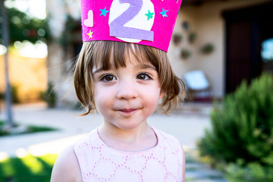 Smiling little child with crown looking at camera
