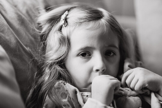 Little girl sucking her thumb