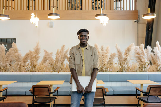 Smiling black self employed man in coworking space