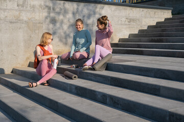 Group of young woman relaxing after training
