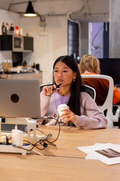 Asian Woman Working With Graphic Tablet In Modern Office