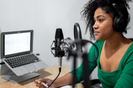 Stylish black woman working in radio studio