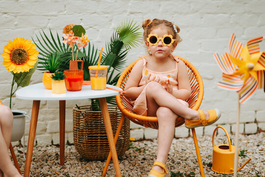 Girl  wearing flower sunglasses and looking super happy