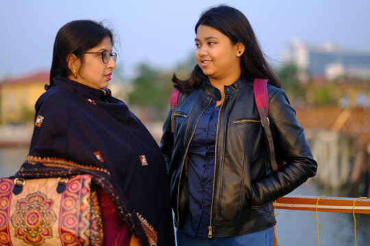Mother and daughter interacting and making conversation at outdoors