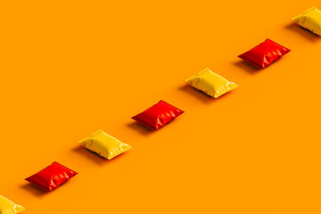 a row of orange and red chips packages with no label.
