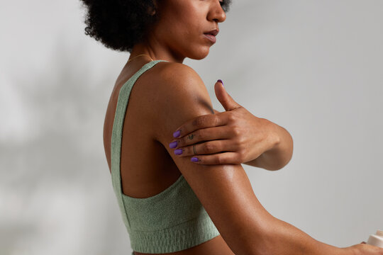 Black Woman Applying Body Cream