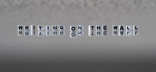 writing on the wall word or concept represented by black and white letter cubes on a grey horizon...