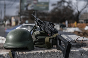 Protective helmet and machine gun on concrete block