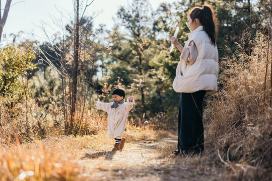 mother and child having fun outdoor.