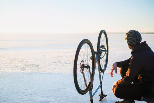 The rider on a bicycle rides on ice