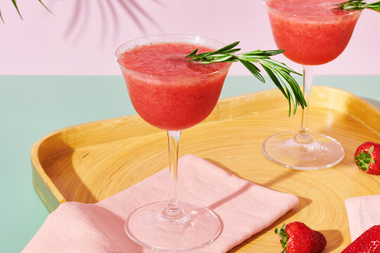 Two Strawberry Cocktails with Palm Leaves 